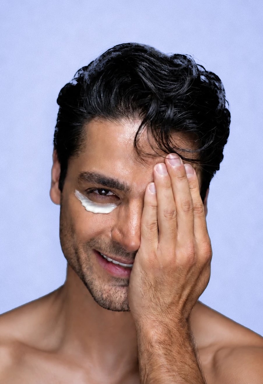 South Asian man wearing white under-eye cream